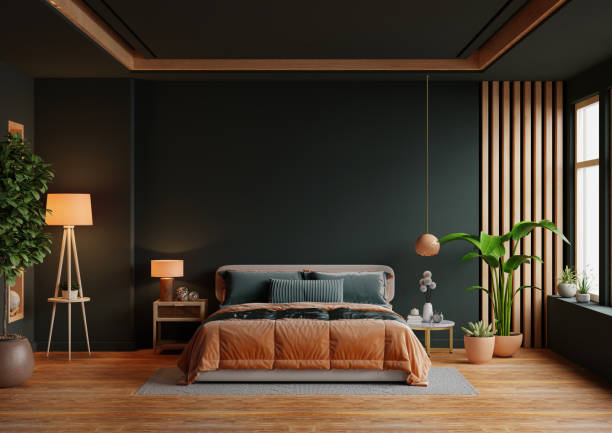 Dark modern bedroom with deep green walls and warm wood accents by a house painter in Dallas, TX